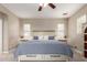 Serene main bedroom with a ceiling fan, neutral tones, and ample natural light from the windows at 15239 W Alexandria Way, Surprise, AZ 85379