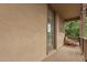A covered patio area with a red chair, overlooking a serene outdoor view at 15239 W Alexandria Way, Surprise, AZ 85379