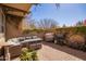 Outdoor patio area with sectional seating, string lights and a grill at 15239 W Alexandria Way, Surprise, AZ 85379