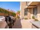 This brick patio features a beautiful flowering wall, a grill, and access to the main house at 15239 W Alexandria Way, Surprise, AZ 85379