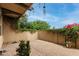 The outdoor patio features brick pavers, string lights, climbing vines and decorative flowers at 15239 W Alexandria Way, Surprise, AZ 85379