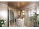 Charming bathroom vanity with an oval mirror and decorative sconces at 15802 N 71St St # 501, Scottsdale, AZ 85254