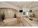 Luxurious bathroom featuring double sinks, soaking tub, and flat screen TV at 15802 N 71St St # 501, Scottsdale, AZ 85254