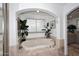 Bright bathtub in a nook with travertine and plants, a tranquil oasis at 15802 N 71St St # 501, Scottsdale, AZ 85254