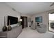 Well-lit bedroom features stylish decor, elegant seating, and a modern entertainment center at 15802 N 71St St # 501, Scottsdale, AZ 85254