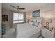 Comfortable bedroom with a large window and a stylish ceiling fan at 15802 N 71St St # 501, Scottsdale, AZ 85254