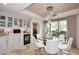 Bright dining area features a glass table, modern lighting, and access to the outdoor patio at 15802 N 71St St # 501, Scottsdale, AZ 85254