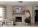 Close-up of the stone fireplace with decorative art and accessories, adding warmth to the room at 15802 N 71St St # 501, Scottsdale, AZ 85254