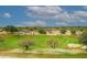 Picturesque golf course view showcases golfers enjoying the sunny day on well-maintained green at 15802 N 71St St # 501, Scottsdale, AZ 85254