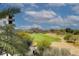 Views of the lush golf course and green foliage from the home's private balcony at 15802 N 71St St # 501, Scottsdale, AZ 85254