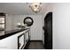 Hallway with arched door, decorative mirror, console table and wood floors at 15802 N 71St St # 501, Scottsdale, AZ 85254