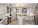 Gourmet kitchen with stainless appliances, a center island, and ample custom cabinetry at 15802 N 71St St # 501, Scottsdale, AZ 85254