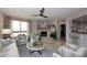 Stylish living area with stone fireplace, modern ceiling fan, and comfortable seating arrangement at 15802 N 71St St # 501, Scottsdale, AZ 85254
