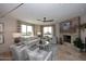 Cozy living room features a stone fireplace, tile flooring, and bright windows with natural light at 15802 N 71St St # 501, Scottsdale, AZ 85254