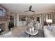 Open-concept living area with a stone fireplace, bar counter, and views of the dining space at 15802 N 71St St # 501, Scottsdale, AZ 85254