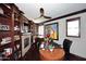 Spacious office with custom built-ins, a brick fireplace, and a ceiling fan at 15802 N 71St St # 501, Scottsdale, AZ 85254
