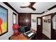 Office featuring wood trim, built-in storage, and a unique ceiling fan at 15802 N 71St St # 501, Scottsdale, AZ 85254