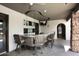 Contemporary outdoor bar area with sleek counter, seating, mounted TV, and stone accent wall at 15802 N 71St St # 501, Scottsdale, AZ 85254
