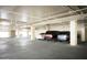 Spacious indoor parking garage with multiple vehicles parked in a bright, well lit area at 15802 N 71St St # 501, Scottsdale, AZ 85254