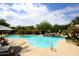 Beautifully landscaped pool area with a waterfall feature and ample seating for relaxation at 15802 N 71St St # 501, Scottsdale, AZ 85254