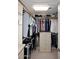 Functional walk-in closet with ample hanging space and built-in drawers at 15802 N 71St St # 501, Scottsdale, AZ 85254
