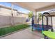 Inviting backyard patio showcasing an artificial grass area, a trampoline, and covered outdoor living space at 1708 W Seagull Ct, Chandler, AZ 85286