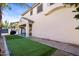 Expansive backyard featuring an artificial grass area, a patio, and a house, perfect for outdoor enjoyment at 1708 W Seagull Ct, Chandler, AZ 85286