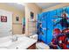 Bathroom with vanity, toilet, and shower featuring a cartoon themed shower curtain at 1708 W Seagull Ct, Chandler, AZ 85286