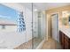 Bright bathroom equipped with a glass shower, mosaic tile floor, and natural light at 1708 W Seagull Ct, Chandler, AZ 85286