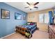 Relaxing bedroom with a cozy bed, blue accent wall, and natural light from the window at 1708 W Seagull Ct, Chandler, AZ 85286