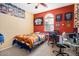 The cozy bedroom features a well-lit room with pictures of sports and memorabilia at 1708 W Seagull Ct, Chandler, AZ 85286