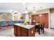 Open floor plan with kitchen island, dining area, living room, and staircase at 1708 W Seagull Ct, Chandler, AZ 85286