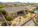 Backyard aerial view of a home featuring an outdoor kitchen, putting green, and patio at 18068 W Narramore Rd, Goodyear, AZ 85338