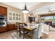 Inviting dining area with a rustic wood table, comfortable chairs, and natural light overlooking the backyard at 18068 W Narramore Rd, Goodyear, AZ 85338