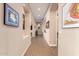 Bright hallway with neutral walls, arched entryways, art niches, and tiled flooring at 18068 W Narramore Rd, Goodyear, AZ 85338