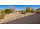 Expansive backyard with desert landscaping, river rock feature, and privacy wall at 18118 W Redwood Ln, Goodyear, AZ 85338
