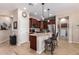 Beautiful kitchen featuring granite countertops, stainless steel appliances, an island with seating, and dark wood cabinets at 18118 W Redwood Ln, Goodyear, AZ 85338