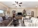 Bright living room with a comfortable sofa, striped armchairs, and stylish decor on display shelves at 18118 W Redwood Ln, Goodyear, AZ 85338