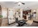 Spacious living area showcasing tile flooring, contemporary furniture, and a seamless open-concept design at 18118 W Redwood Ln, Goodyear, AZ 85338