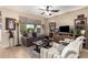 Cozy living room with tile floors, a large window, and stylish furnishings, creating a welcoming space at 18118 W Redwood Ln, Goodyear, AZ 85338