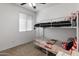 Bedroom featuring bunk beds and natural light from a window at 18359 W Tina Ln, Surprise, AZ 85387