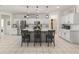 Contemporary kitchen with stainless steel appliances, a gray island, and stylish pendant lights at 18359 W Tina Ln, Surprise, AZ 85387