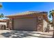 Desert home with stone accents, tile roof and a two-car garage at 18665 N Patina Ct, Surprise, AZ 85387