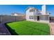 Exterior view of a backyard featuring a grassy lawn and an enclosed patio at 19437 N 43Rd Dr, Glendale, AZ 85308