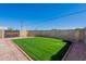 A fenced backyard featuring a well-maintained lawn and rock landscaping for easy upkeep at 19437 N 43Rd Dr, Glendale, AZ 85308