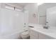 Well-lit bathroom with white tiled shower and tub, white vanity with mirror at 19437 N 43Rd Dr, Glendale, AZ 85308