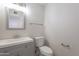 Bathroom features a framed mirror and vanity and a toilet at 19437 N 43Rd Dr, Glendale, AZ 85308