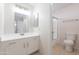 Bright bathroom featuring a white vanity with a framed mirror and a shower with glass doors at 19437 N 43Rd Dr, Glendale, AZ 85308