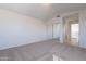 Bedroom featuring carpet flooring, a mirrored closet, and an ensuite bathroom entrance at 19437 N 43Rd Dr, Glendale, AZ 85308
