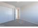 Bedroom featuring neutral carpeting, a closet with sliding doors, and light walls at 19437 N 43Rd Dr, Glendale, AZ 85308